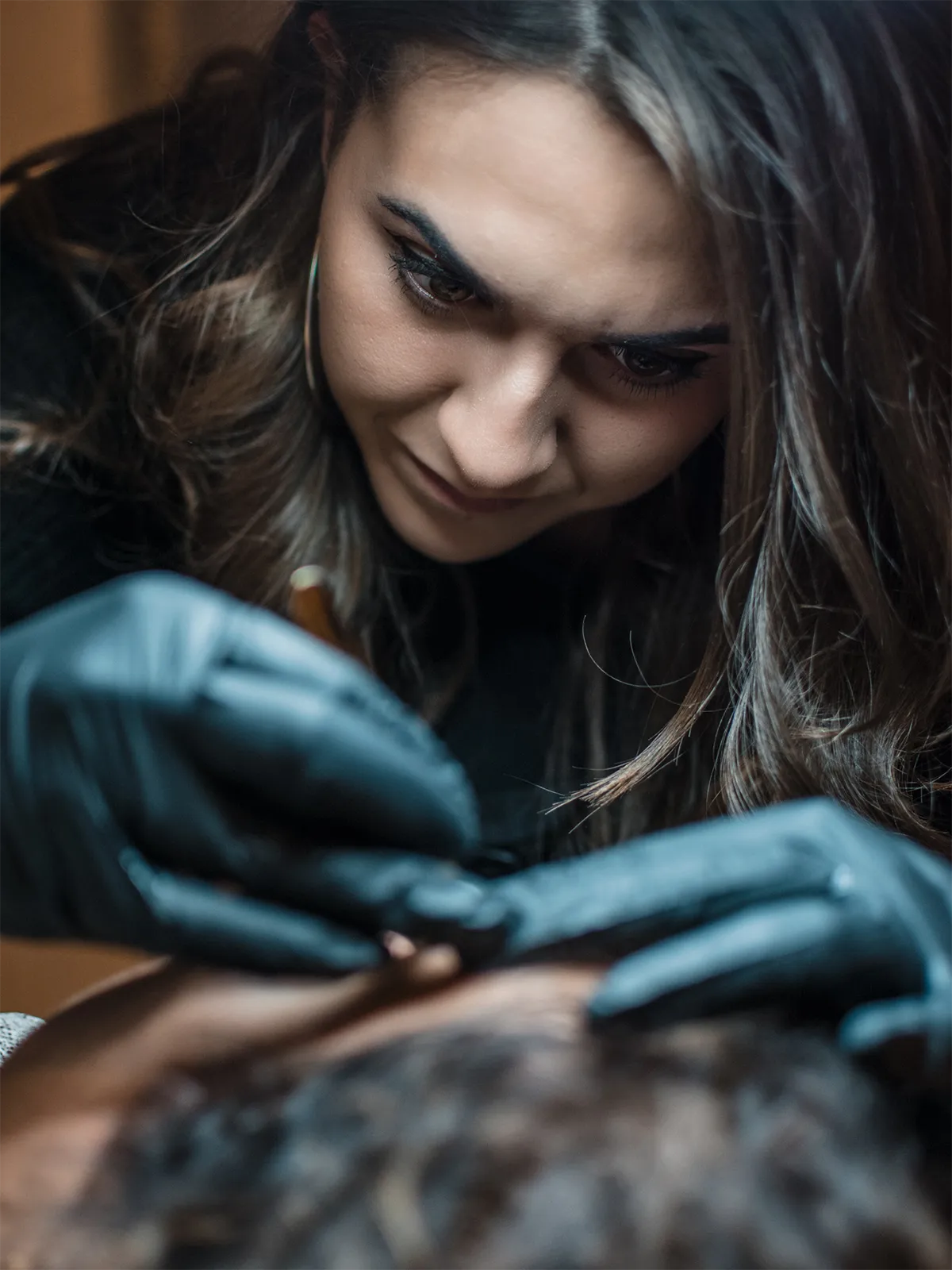 Close-up of a client receiving a brow touch-up by semi-permanent make-up artist Tineke Colonna